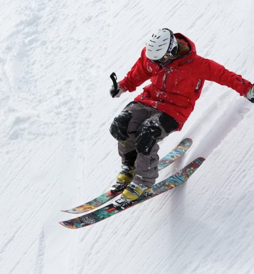 man-in-red-jacket-playing-ice-skates-during-day-time-47356