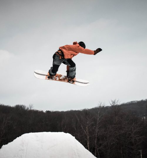 man-in-snowboard-jumping-on-ramp-1635086